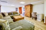 Lower level family room with TV, large sectional sofa and foosball table